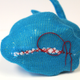 A knitted Stanford bunny skin (left), stuffed and sewn shut (center), viewed from the front (right).